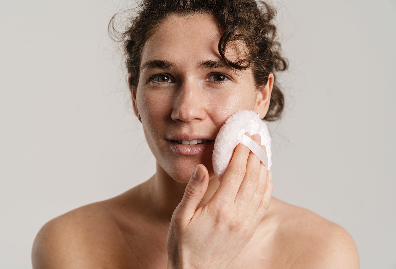 Woman practicing mindful skincare ritual with intentional self-care and wellness