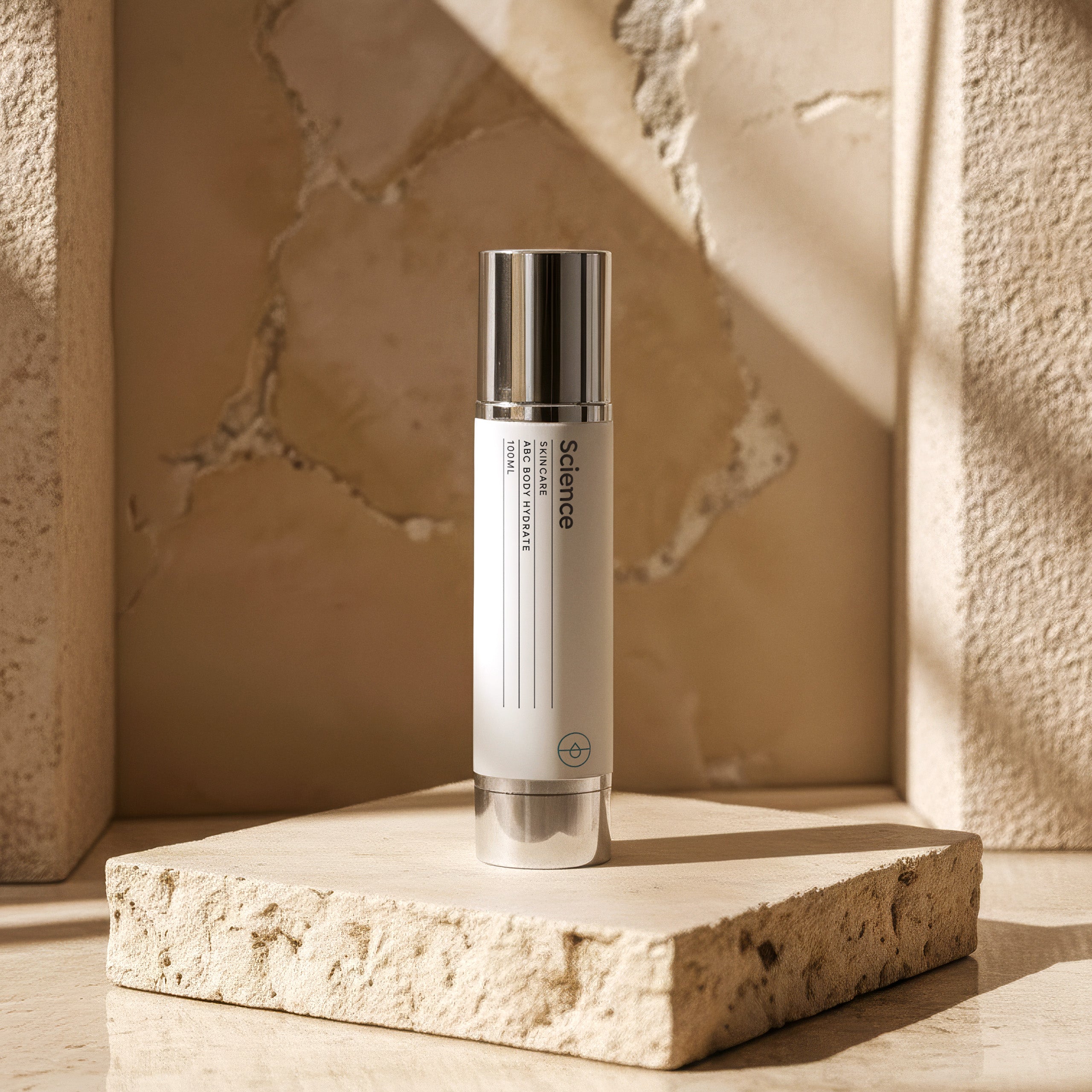 ABC Hand + Body Hydrate 100ml on stone background - intense hydrating lotion with vitamins A, B, C, E and hyaluronic acid for hands and body, soothes and nourishes dry skin
