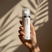 Carbon Cleanser lifestyle image showing black charcoal face wash with tea tree, bilberry and lemon extract for detoxifying oily skin, preventing breakouts and folliculitis
