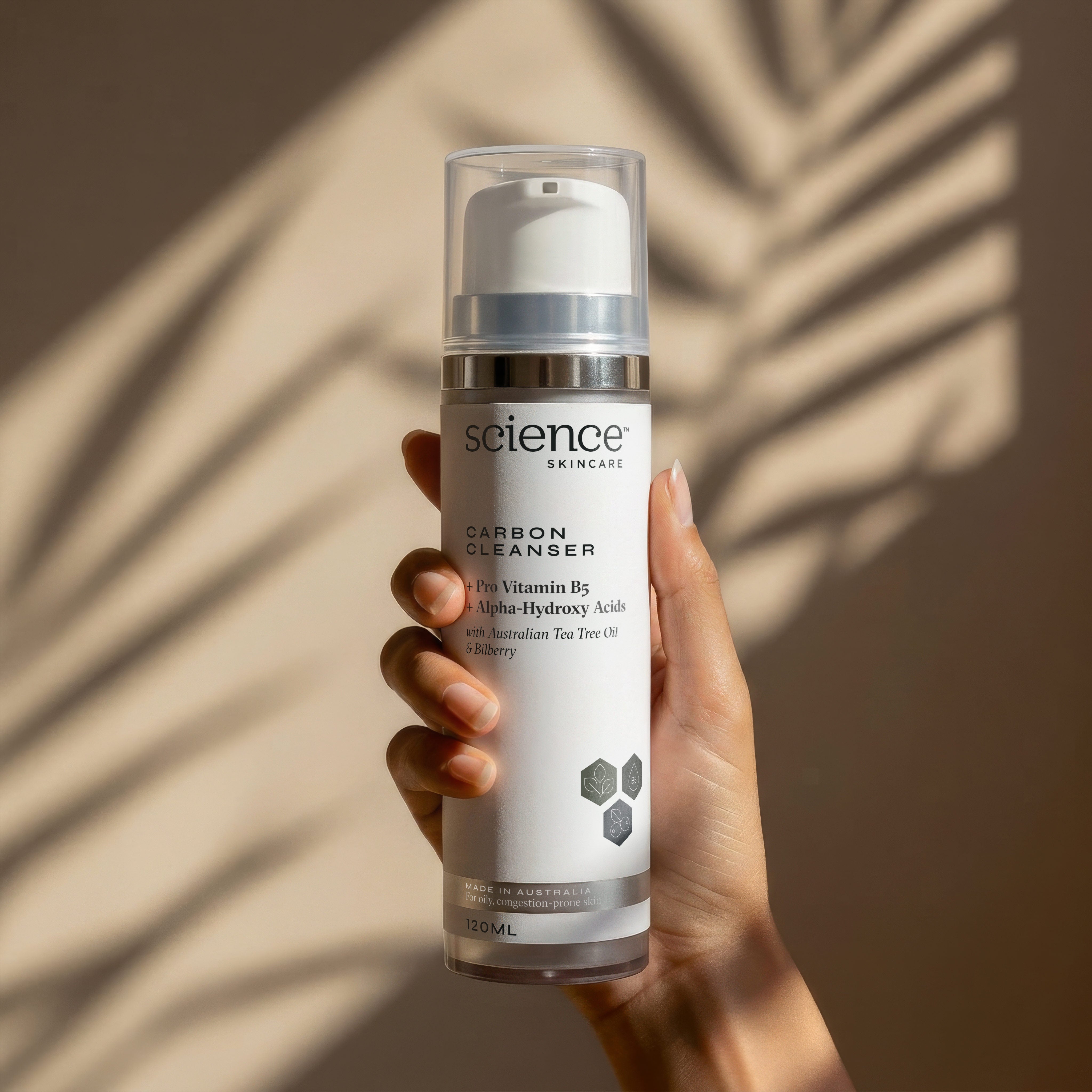 Carbon Cleanser lifestyle image showing black charcoal face wash with tea tree, bilberry and lemon extract for detoxifying oily skin, preventing breakouts and folliculitis
