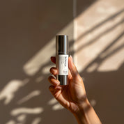 Exfoliant Serum AHA + BHA lifestyle image showing resurfacing serum with vitamin A, botanical extracts and fruit acids for clearing breakouts, refining pores and calming redness