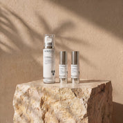 Mankind Collection lifestyle image showing Carbon Cleanser, Clear + Calm Serum and Vitamin A 0.5% + B3 Serum by Science Skincare, styled on a raw stone plinth with natural shadow play
