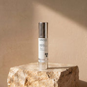 Suntint Protect Dark SPF-25 lifestyle image showing the 50ml Science Skincare tinted sunscreen styled on a raw stone plinth with natural shadow play