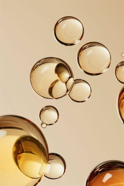 Golden serum droplets representing Vitamin A